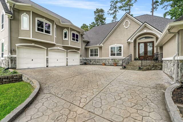 view of front of home with french doors and a garage