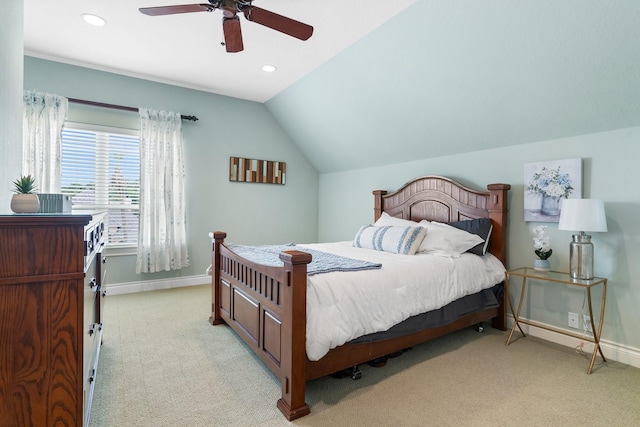 bedroom with ceiling fan, vaulted ceiling, and light colored carpet