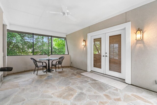 sunroom / solarium with ceiling fan and french doors