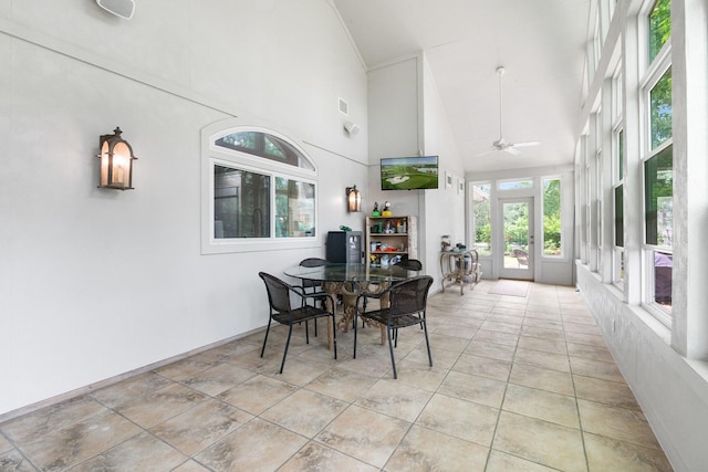 dining area featuring ceiling fan and high vaulted ceiling