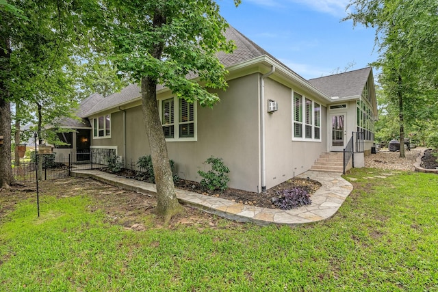 view of side of property with a lawn