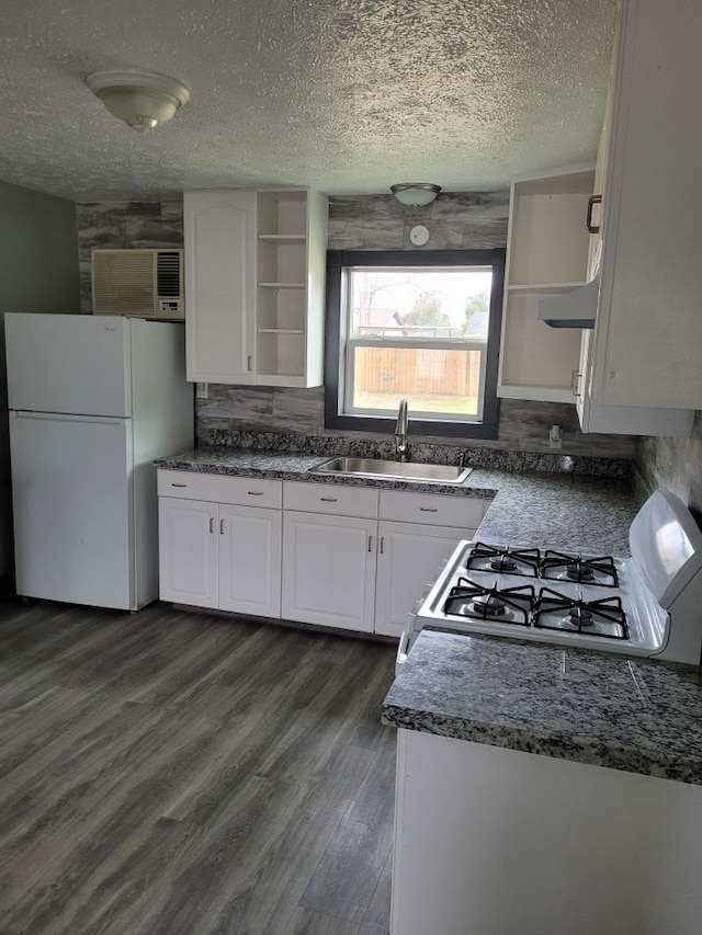 kitchen with dark wood-type flooring, white refrigerator, range, white cabinets, and sink