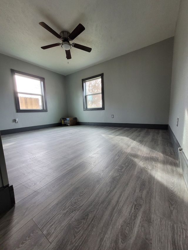 spare room featuring ceiling fan and hardwood / wood-style flooring