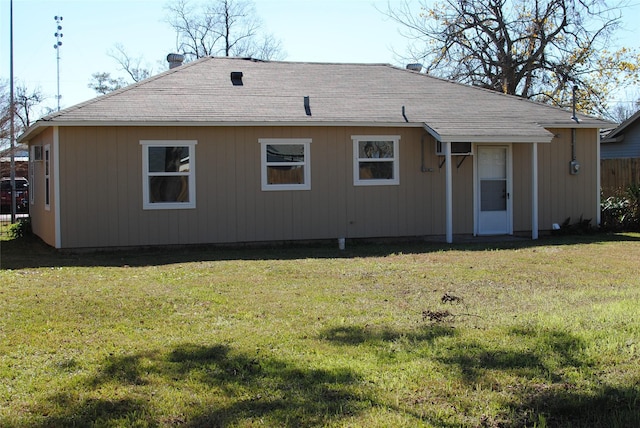 back of property featuring a lawn