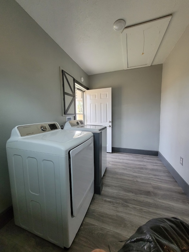 laundry area featuring dark hardwood / wood-style floors and washer and dryer