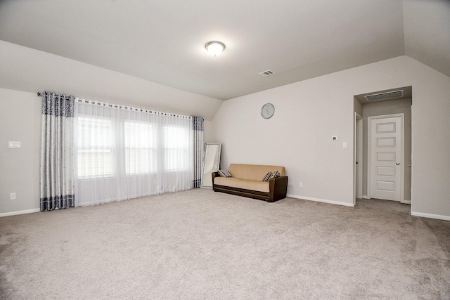 unfurnished room with vaulted ceiling and light colored carpet