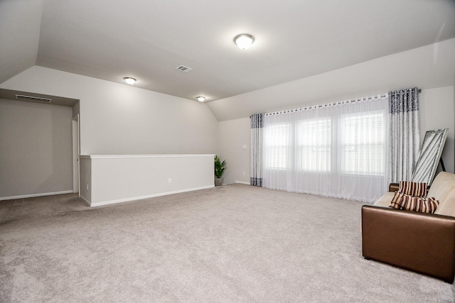 sitting room with light carpet and lofted ceiling