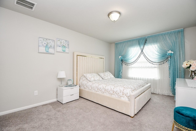 bedroom with light colored carpet