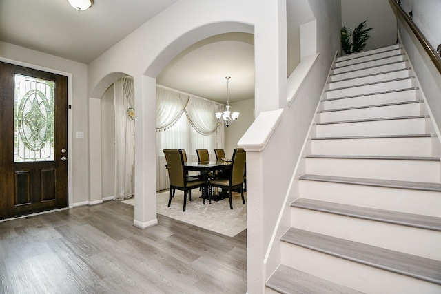 entrance foyer with hardwood / wood-style flooring and a notable chandelier