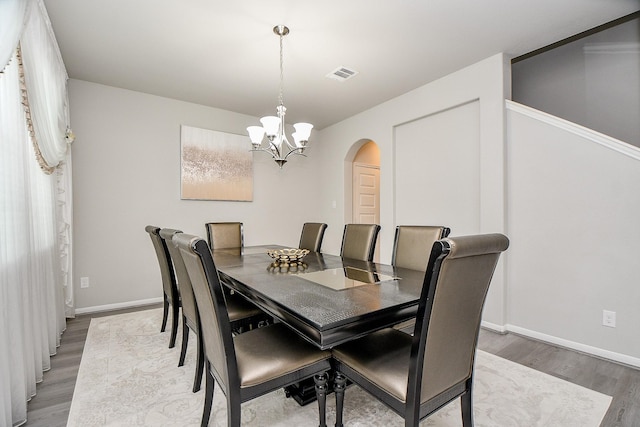 dining room featuring an inviting chandelier and hardwood / wood-style flooring