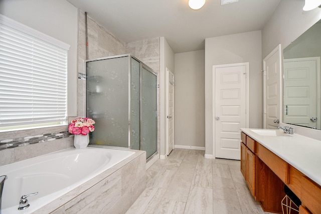 bathroom featuring vanity and shower with separate bathtub