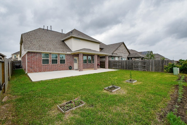 rear view of property with a patio area and a lawn