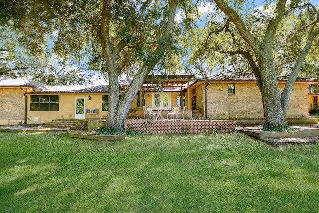 back of house featuring a wooden deck and a lawn