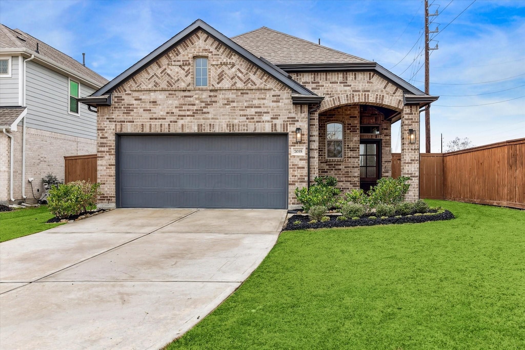 view of front of property with a garage and a front lawn