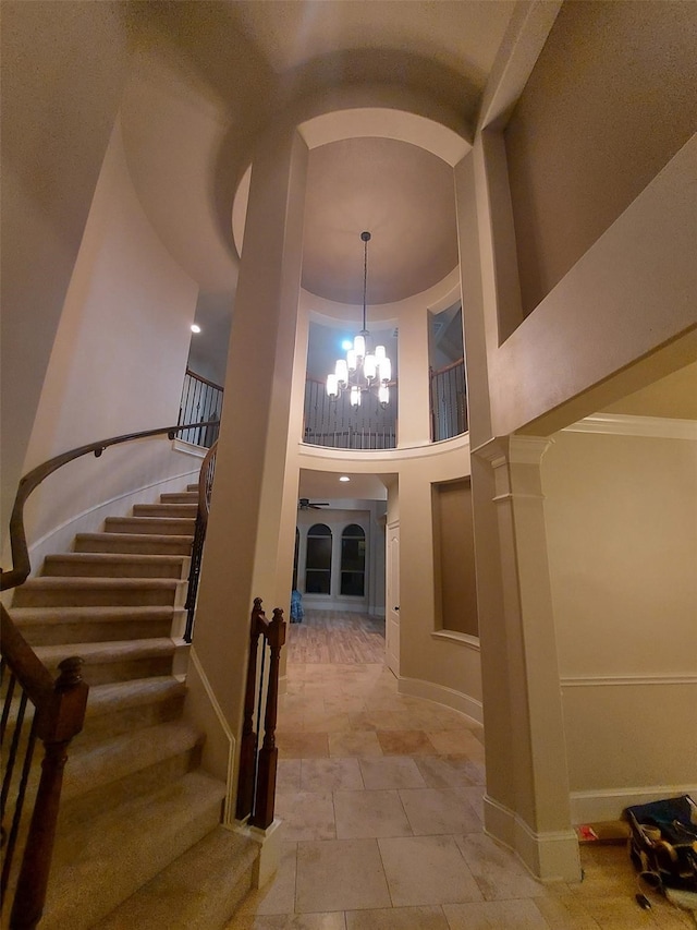 entrance foyer with a towering ceiling and a notable chandelier