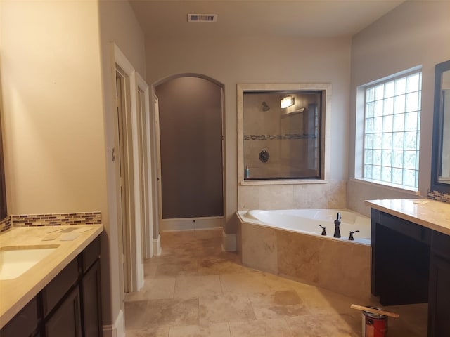 bathroom with vanity and independent shower and bath