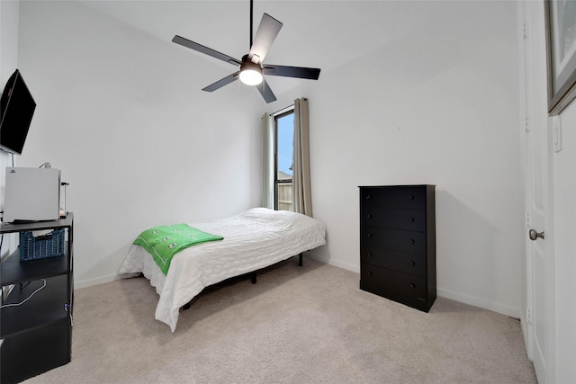 carpeted bedroom featuring ceiling fan and vaulted ceiling