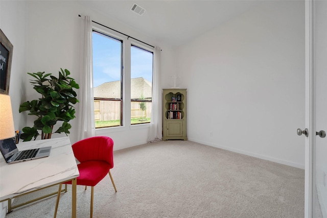 carpeted office space featuring vaulted ceiling