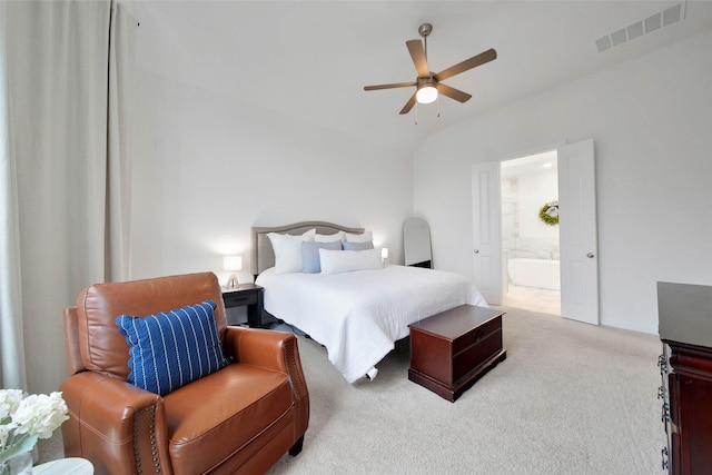 bedroom with ceiling fan, lofted ceiling, connected bathroom, and carpet floors