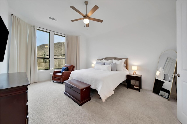 bedroom with ceiling fan and light carpet