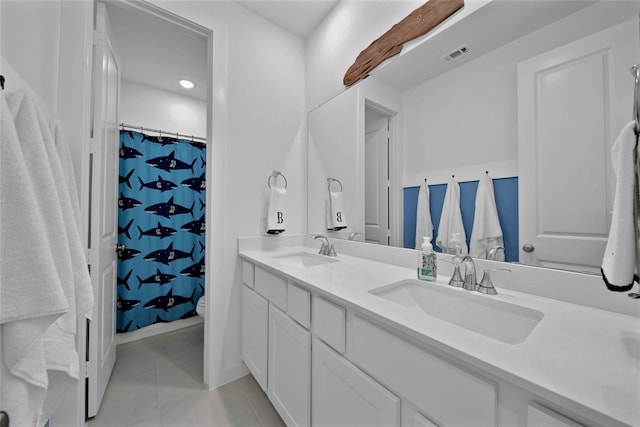 bathroom with toilet, vanity, tile patterned flooring, and curtained shower