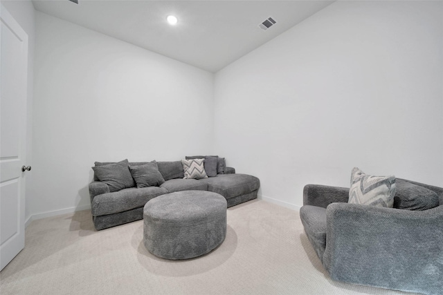 sitting room with vaulted ceiling and carpet floors