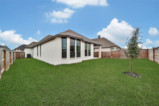 rear view of property with a lawn