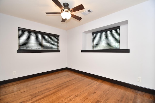 empty room featuring ceiling fan and wood-type flooring