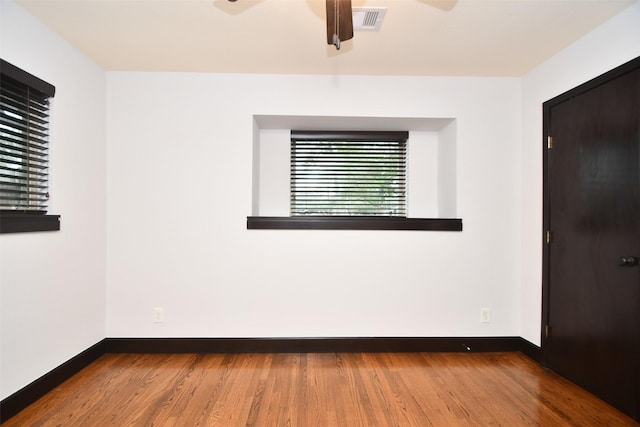 spare room featuring ceiling fan and wood-type flooring