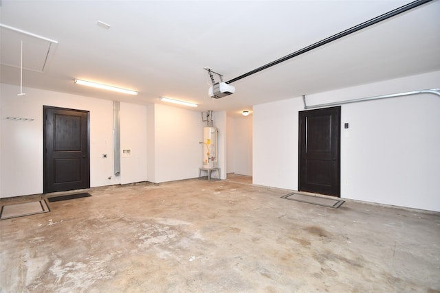 garage featuring water heater and a garage door opener