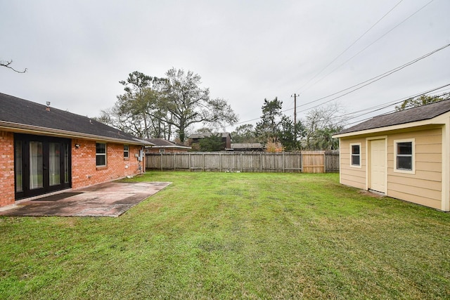 view of yard with french doors and a patio