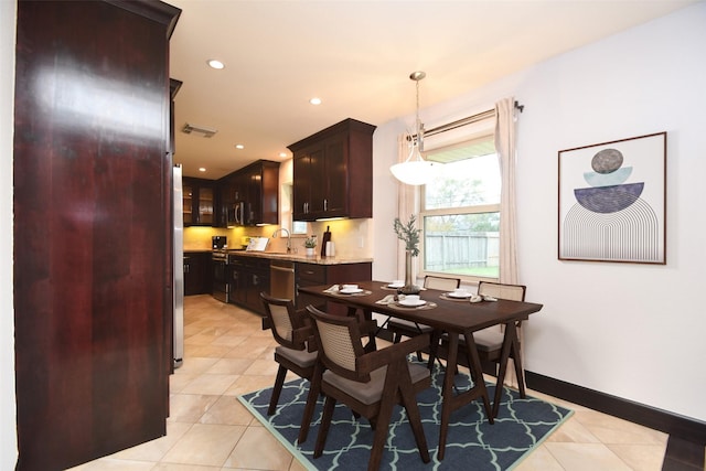 dining room featuring light tile patterned floors and sink