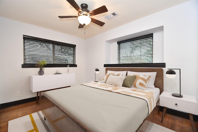 bedroom featuring ceiling fan and dark hardwood / wood-style floors