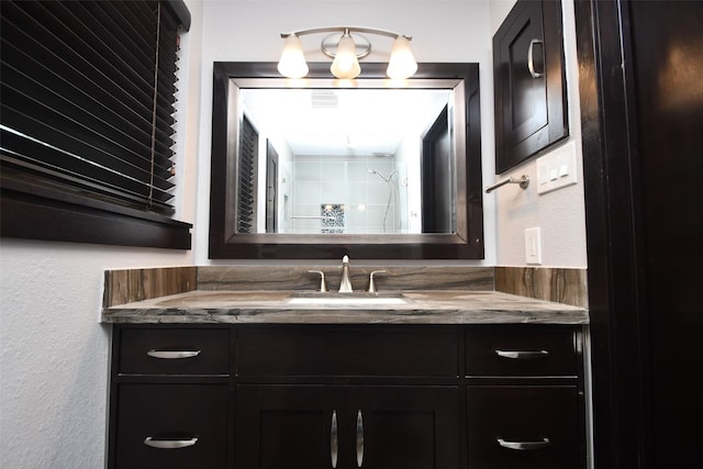 bathroom with vanity and a shower