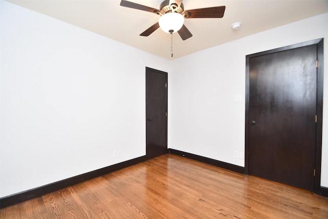 unfurnished bedroom with ceiling fan, light wood-type flooring, and a closet