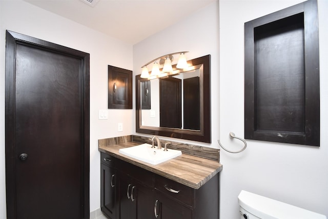 bathroom featuring toilet and vanity