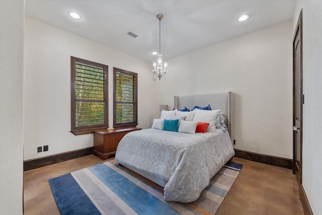 bedroom with concrete flooring and a notable chandelier