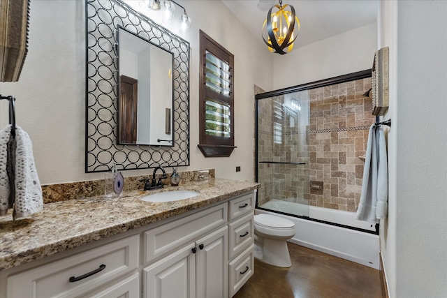 full bathroom with toilet, a notable chandelier, vanity, and shower / bath combination with glass door