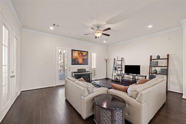 living room featuring crown molding, ceiling fan, and dark hardwood / wood-style floors