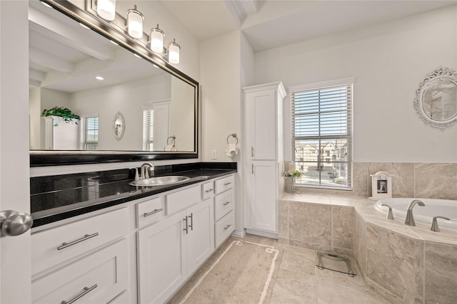 bathroom featuring vanity and tiled bath