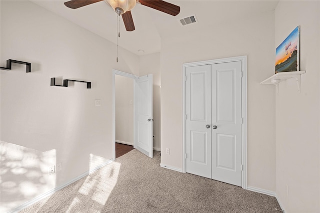 unfurnished bedroom featuring carpet floors, a closet, and ceiling fan