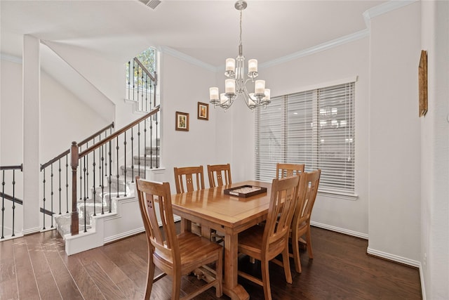 dining space with a notable chandelier, ornamental molding, and dark hardwood / wood-style floors