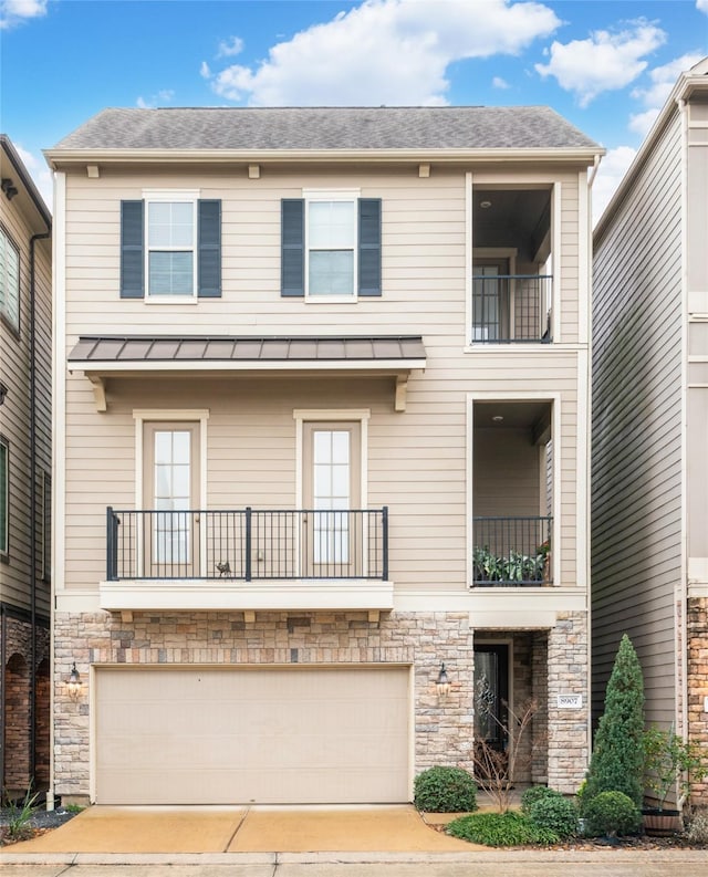 view of front of home featuring a garage and a balcony