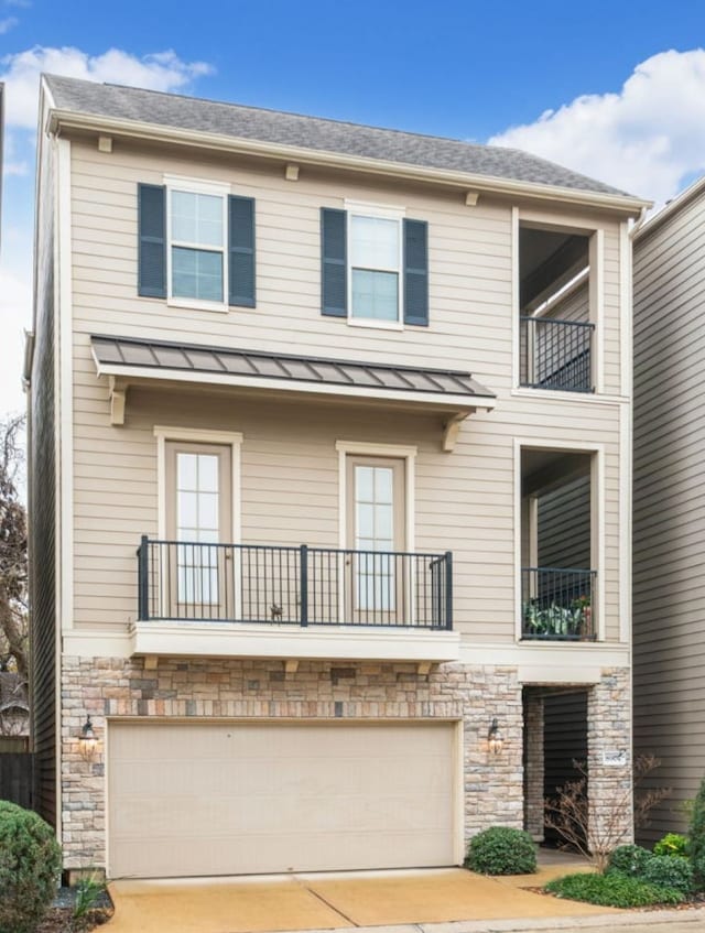 view of front of home with a garage and a balcony