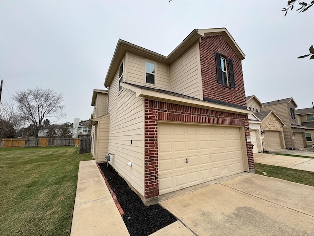 view of side of home featuring a garage and a yard