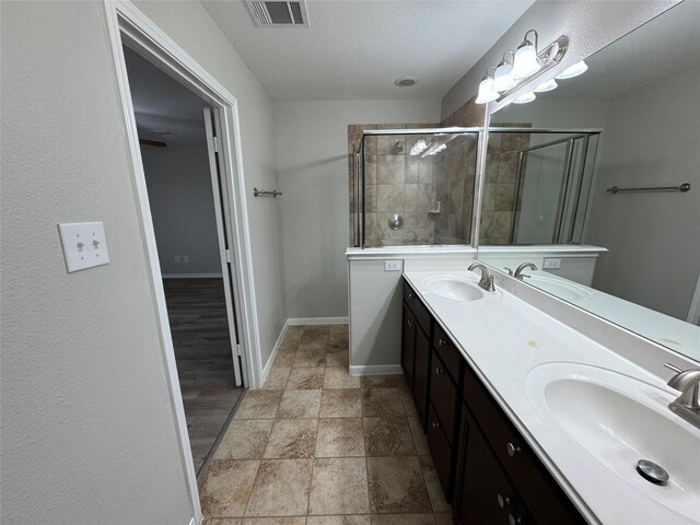 bathroom featuring walk in shower and vanity