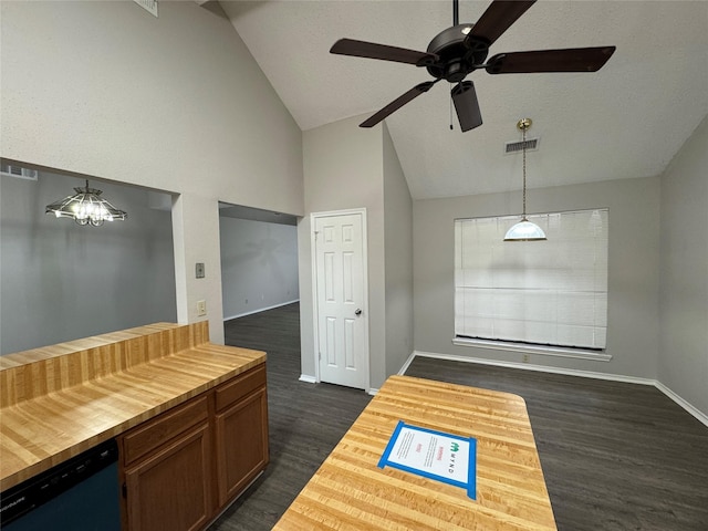 kitchen featuring butcher block counters, dark hardwood / wood-style flooring, dishwasher, high vaulted ceiling, and pendant lighting