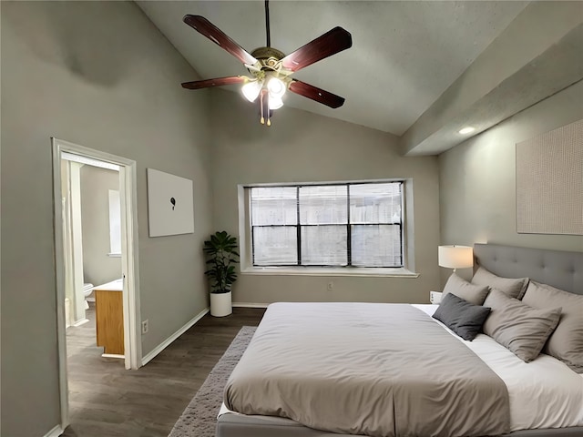 bedroom featuring dark wood-type flooring, ceiling fan, lofted ceiling, and ensuite bath