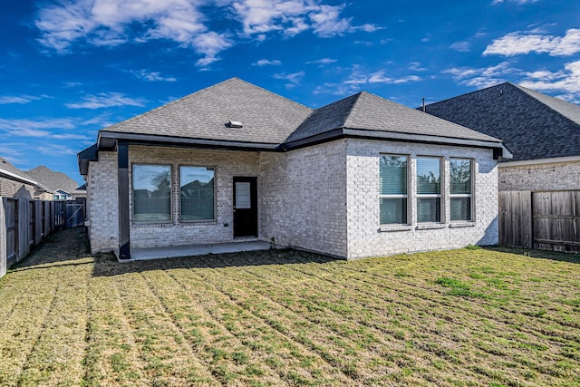 rear view of house featuring a yard