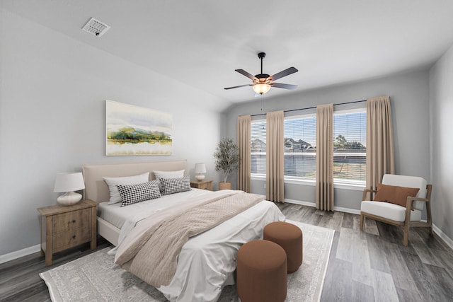 bedroom with ceiling fan, lofted ceiling, and hardwood / wood-style flooring